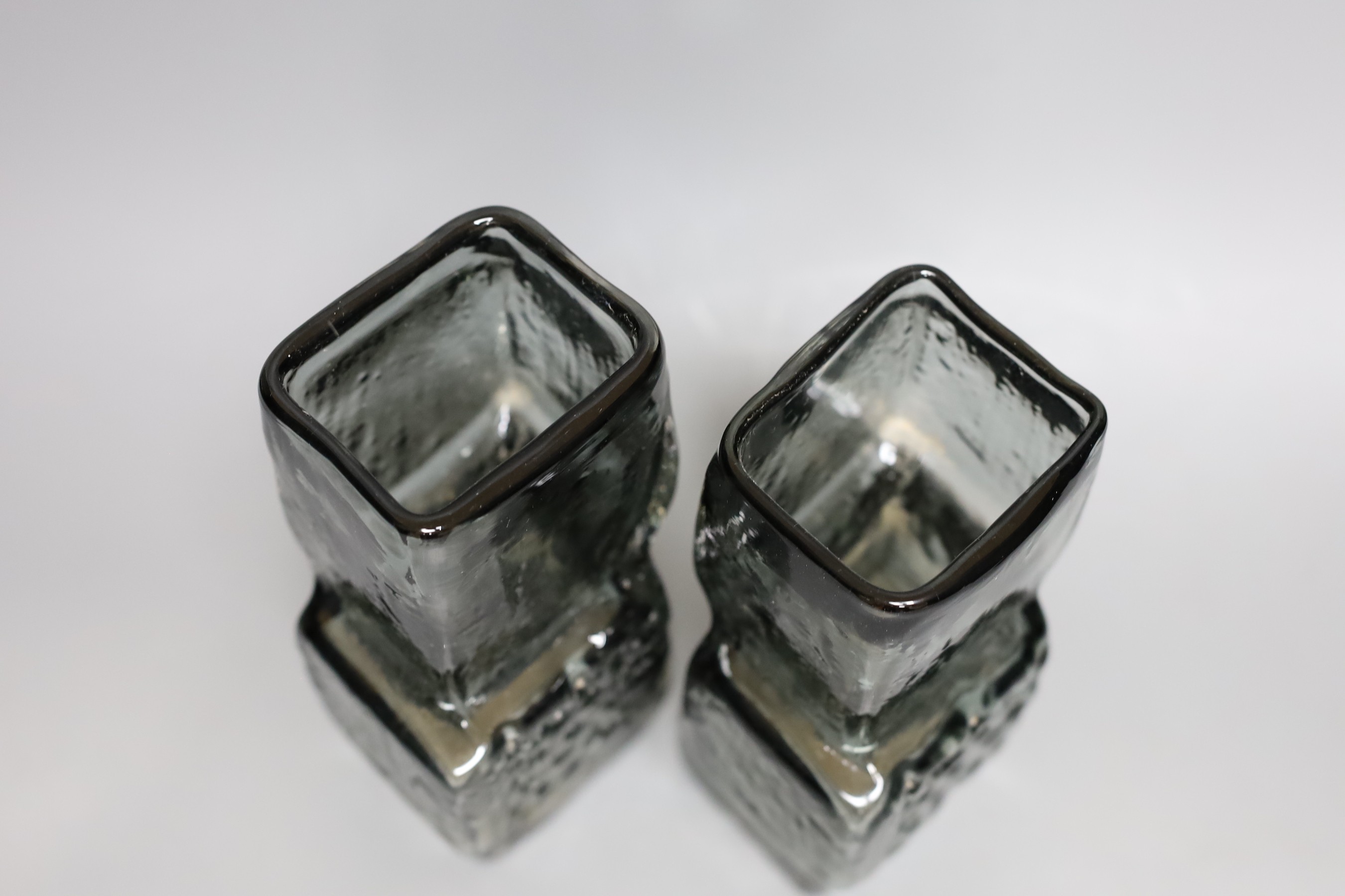 A pair of Whitefriars 'Drunken Bricklayer's' glass vases, designed by Geoffrey Baxter, pattern number 9673, smoked glass, 20cm tall